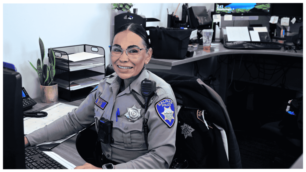 A Salinas Police Department Community Service Officer works at her desk, completing essential administrative tasks before returning to her usual field‑based duties.